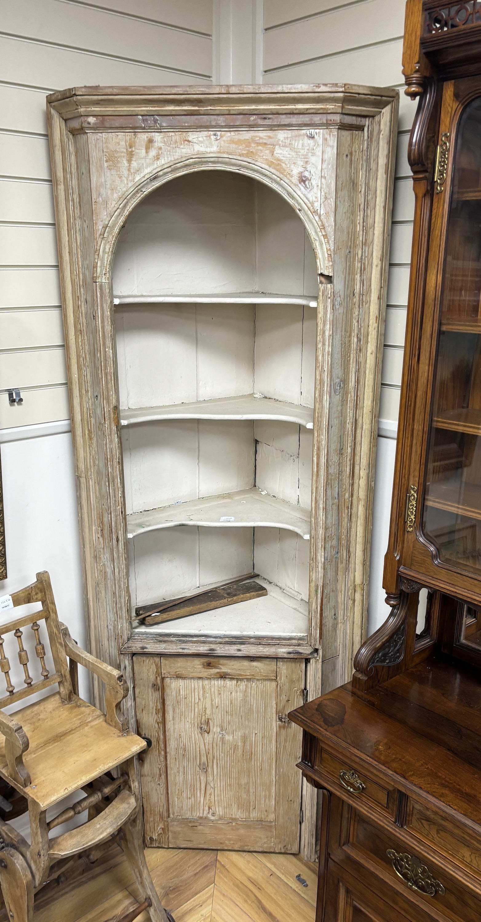 A 19th century pine standing corner cupboard, width 82cm, depth 42cm, height 210cm. Condition - poor, Provenance- Brede Place, East Sussex, a former residence of the Frewen family from 1712-1936.